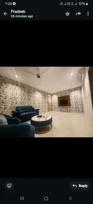 a living room with a couch and a table and chairs at VV's Lakshmi Inn in Thekkumkara