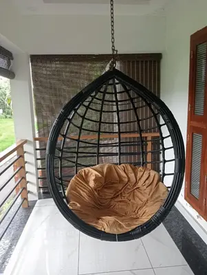 a hanging bed in a cage on a porch at Izzath in Kottakkal