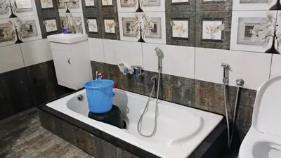 a bathroom with a sink with a shower in it at Cozy Corner in Alwaye