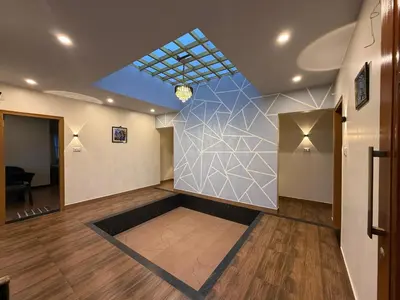 a large room with a wall with a geometric design at Humming Bird suite in Kotagiri