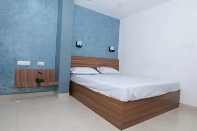 a bedroom with a bed in a blue room at Balu Residency - A Business Class Hotel in Coimbatore