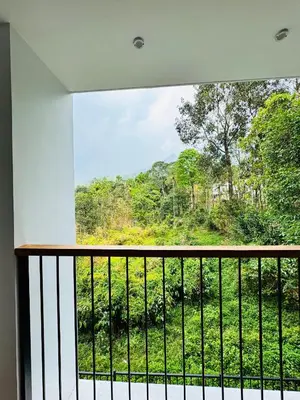 a room with a balcony with a view of a forest at AYD-IN BY GREENLEAVES Resort in Vythiri
