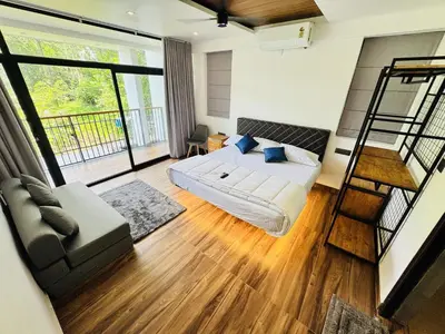 a bedroom with a bed and a ladder at AYD-IN BY GREENLEAVES Resort in Vythiri