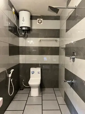 a bathroom with a toilet and a sink at Jungle flare in Hampāpura
