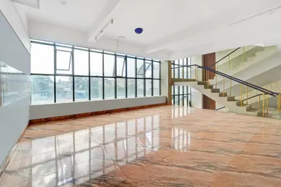 an empty room with stairs and glass windows at Super Hotel O Tiruppur Near Railway station in Tiruppūr