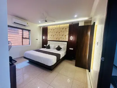 a bedroom with a large bed in a room at Mysore Elite in Mysore