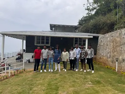 a group of people standing in front of a house at The Plum Castle in Kodaikānāl