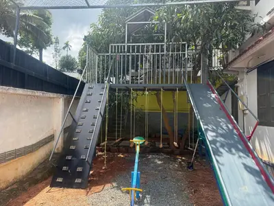a playground with a slide in a building at 2 Empire One Bedroom with Common Pool in Wayanad