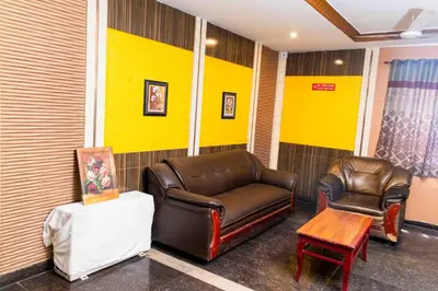 a waiting room with a leather couch and a table at Hotel DRG Heritage in Tiruppūr