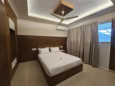 a bedroom with a bed and a ceiling fan at Airport Tree in Nedumbassery