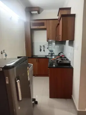a kitchen with a sink and a counter top at Airport Tree in Nedumbassery