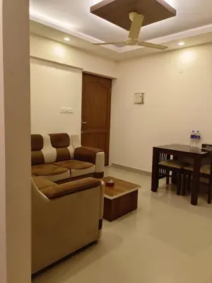 a living room with a couch and a table at Airport Tree in Nedumbassery