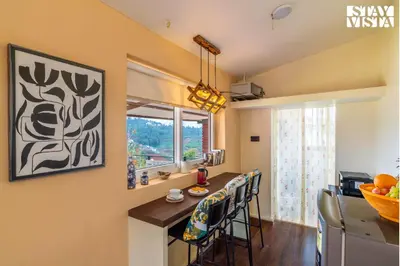 a kitchen with a counter and a window at StayVista at Valley Whispers with BBQ & Bonfire in Ooty