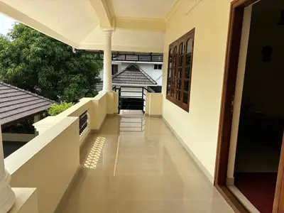 an empty hallway of a house with a balcony at Serene Nest Apartment-Kochi Airport in Nedumbassery