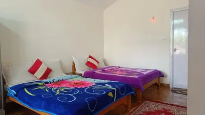a room with two beds sitting next to each other at Vi stays in Ooty