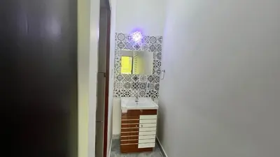 a bathroom with a sink and a mirror at Portico Resorts in Pandalūr