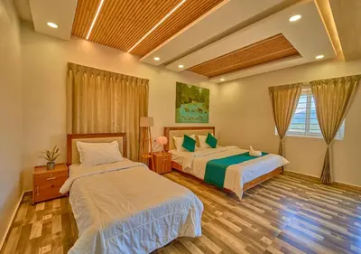 a bedroom with two beds in a room at Vihani's Western Clouds Ooty by VOYE HOMES - Peaceful Getaway Near Avalanche Emerald Lake in Ooty