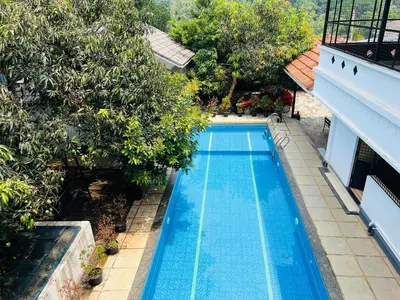 an overhead view of a swimming pool with trees at 3 Empire One Bedroom with Common Pool in Wayanad