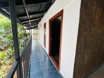 a hallway of a house with an open door at 3 Empire One Bedroom with Common Pool in Wayanad
