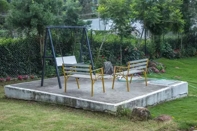 two benches on a swing set in a yard at Onella in Yedapalli