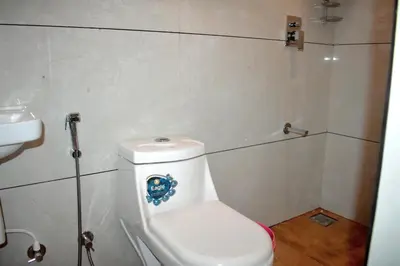 a small bathroom with a toilet and a sink at Green Heaven Kuruva Wayanad in Chekadi
