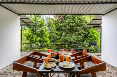 a table with food on it on a patio at Interlaken - 4 BR VIlla in Yedapalli