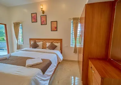 a bedroom with two beds and a dresser in it at Central Homestay Ooty by VOYE HOMES Family-Friendly Budget Stay with Valley And Mountain Views in Ooty