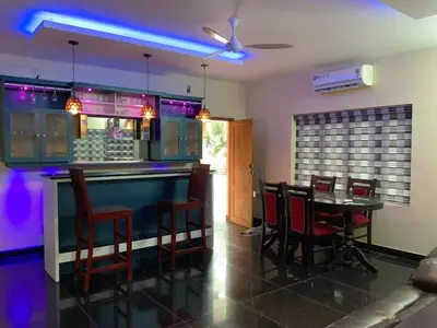 a bar with chairs and a table in a room at 
