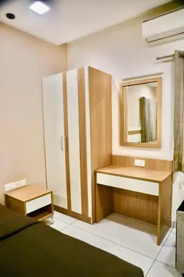a bathroom with a sink and a mirror at Virksham Hotel in Coimbatore