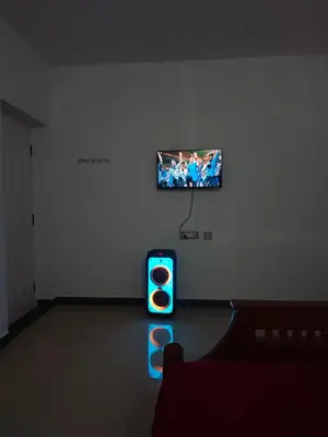 a living room with a tv and a traffic light at Jazz&Hill in Kodaikānāl