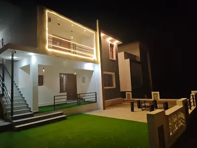 a house with a green lawn in front of it at Jazz&Hill in Kodaikānāl