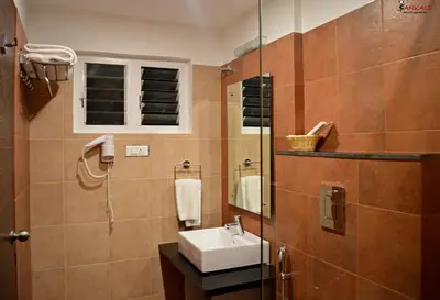 a bathroom with a sink and a mirror at Sepoy Grande Mysore in Mysore