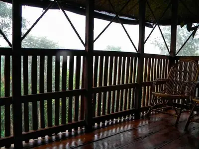a wooden porch with a bench and a window at Greens Tree House & Wood House in Sultan Bathery