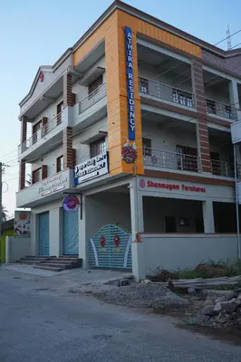 a building with a sign on the side of it at Athira Residency Coorg in Kushālnagar