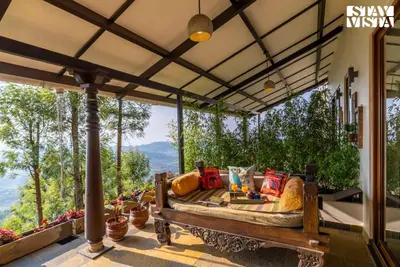 a porch with a couch on a patio at StayVista at Under the Stars Lovedale ooty in Ooty