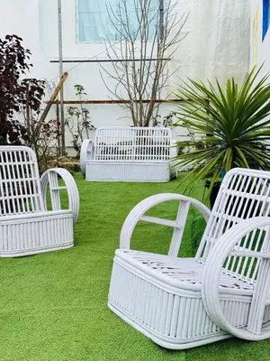 a group of white chairs sitting on the grass at Urban Lush in Ooty