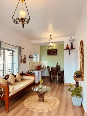 a living room with a couch and a table at Urban Lush in Ooty