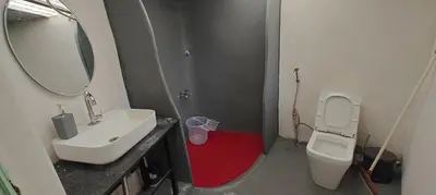 a bathroom with a sink and a toilet and a mirror at Moonrise Kingdom Permaculture Farm Stay in Hura