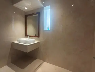 a bathroom with a sink and a mirror at Gulzar 1BHK Service Apartment, kannur in Kannur