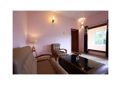 a living room with a couch and a table at The Forest Haven in Ooty