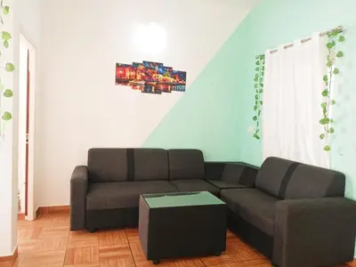 a living room with a couch and a table at Boganvilla, Magic Land Resort in Athirappilly