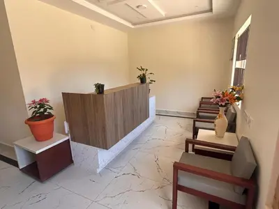 a lobby with a reception desk and potted plants at Rio Grande Retreat in Kodaikānāl