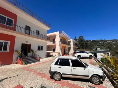 a white car parked in front of a building at Rio Grande Retreat in Kodaikānāl