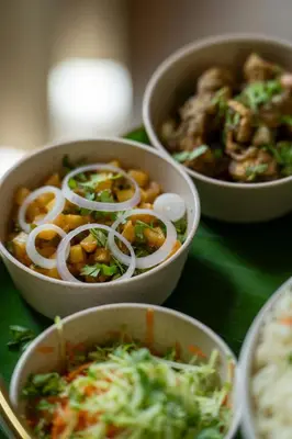 three bowls of food on a green table at Yanai at Anai - Private Pool & Private Cook in Varagampadi