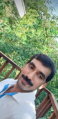 a man with a beard and mustache laying down at Wayanad Haven Villa in Wayanad