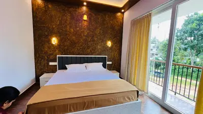 a bedroom with a bed and a large window at Wayanad Haven Villa in Wayanad