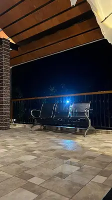 a bench sitting on a patio at night at Wayanad Haven Villa in Wayanad