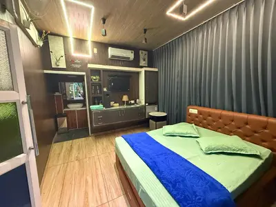 a bedroom with a bed and a television in it at JOHNS VILLAGE Resorts in Vallikavungal