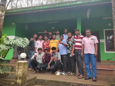 a group of people posing for a picture in front of a building at Green wayanad homestay in Kenichira