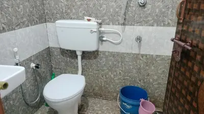 a bathroom with a toilet and a sink at Aswathy Bhavan in Vadakkāncheri